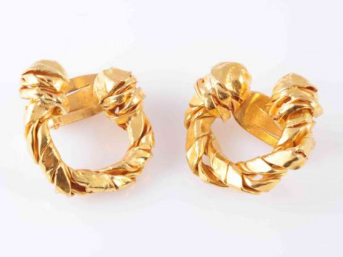 A PAIR OF GOLD COLOURED EARRINGS, of faceted hoop design with moulded...