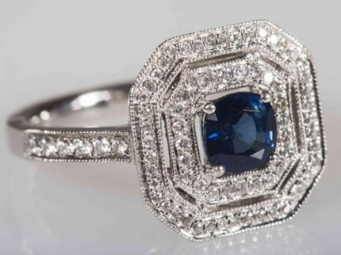 A SAPPHIRE AND DIAMOND RING, the cushion mixed cut sapphire four claw...