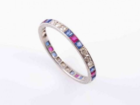 A SAPPHIRE, RUBY AND DIAMOND ETERNITY RING, the five sets of three brilliant...