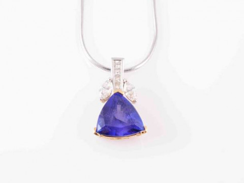 A TANZANITE AND DIAMOND NECKLACE, the trillion-cut tanzanite with three...