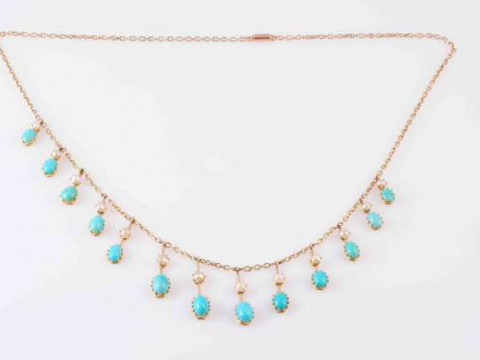 A TURQUOISE AND PEARL NECKLACE, CIRCA 1890, the thirteen graduating oval...