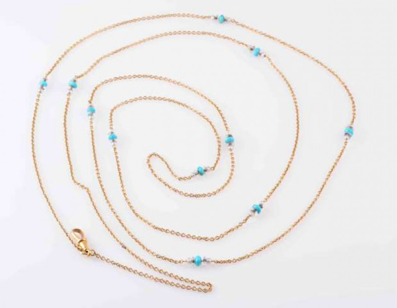 A TURQUOISE AND SEED PEARL SET WATCH CHAIN, CIRCA 1900, the double row fine oval link chain set throughout with eleven clusters of a single turquoise bead highlight, two seed pearl highlights and two rock crystal bead highlights, on an Albert clasp. Total