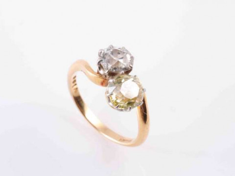 A TWO STONE DIAMOND RING, CIRCA 1890, the two old brilliant-cut diamonds...