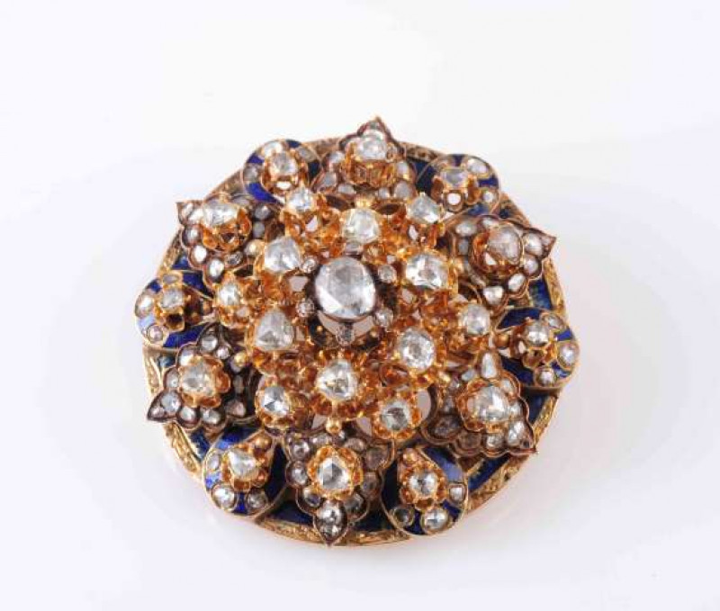 A VICTORIAN DIAMOND, ENAMEL AND GOLD BROOCH, CIRCA 1860, the circular mount, with chased detail to the edge and blue enamel decoration set below a tapering star set mount of rose-cut diamonds. Brooch-pin fitting. approximately 4 cm diameter. Total weight 