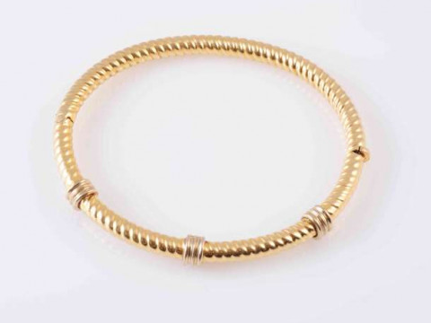 A YELLOW GOLD COLOURED BANGLE, the rope work design bangle with three...