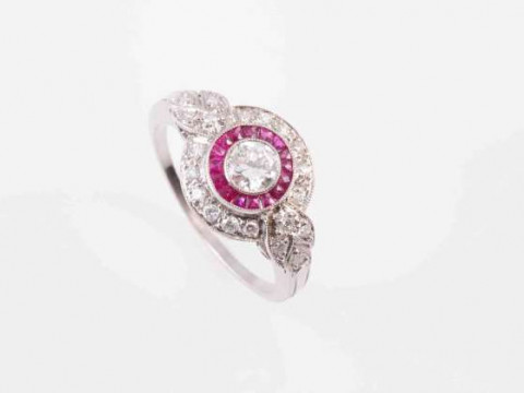 AN ART DECO RUBY AND DIAMOND RING, the brilliant cut collet set diamond...