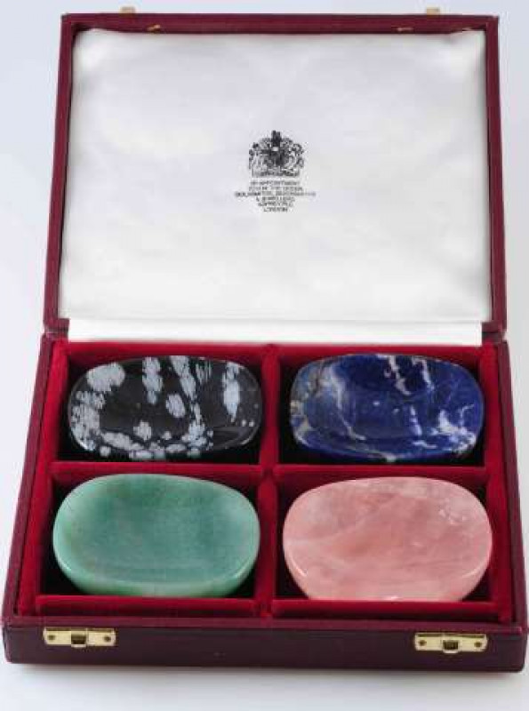 A SET OF FOUR GEMSTONE SALTS, of rounded rectangular form, in an Asprey box. Each 4.5cm by 6cm