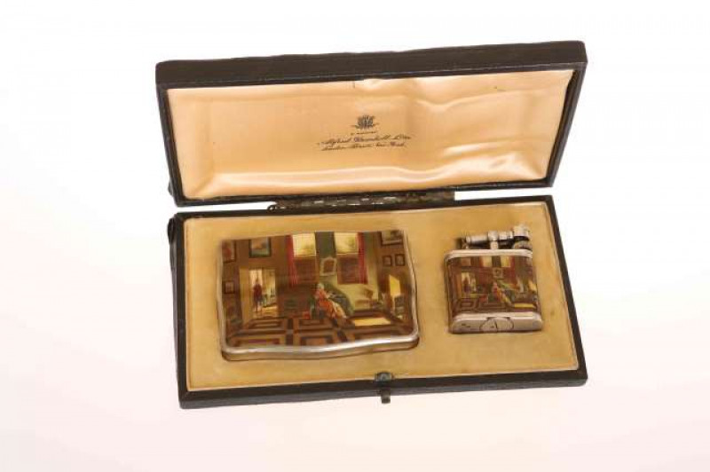 DUNHILL, A SILVER AND ENAMEL CIGARETTE CASE AND LIGHTER, each decorated with a pictorial enamel of a lady reading at a table with a dog at her side, the interior hung with pictures, the cigarette case, stamped STERLING and with BF maker's mark, further