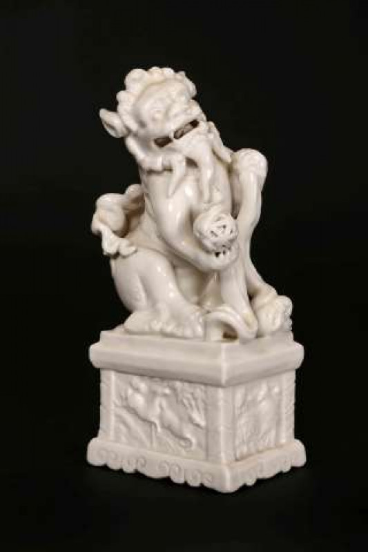 A CHINESE BLANC-DE-CHINE MODEL OF A FU DOG, possibly 19th Century. 22cm