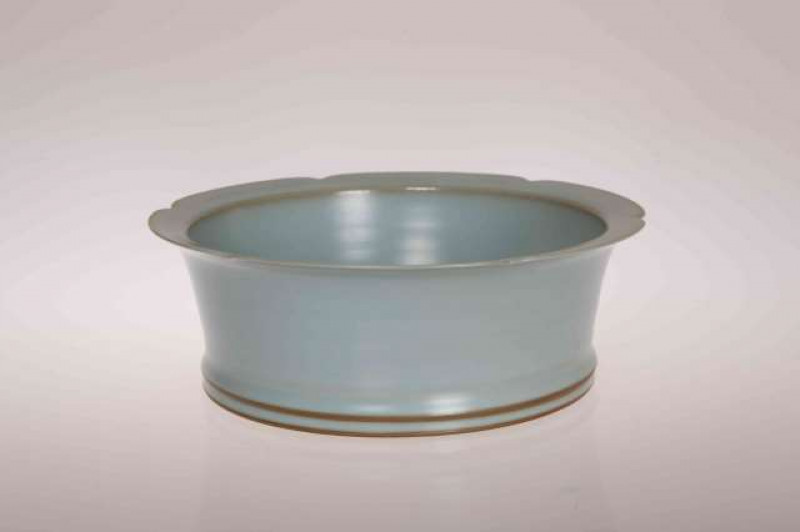 A CHINESE CELADON BOWL, with shaped rim. 20cm wide