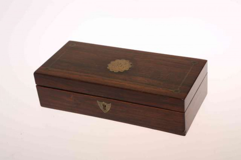 A 19TH CENTURY BRASS AND ROSEWOOD TRAVELLING PEN BOX, the interior with inkwell and covered boxes. 19cm wide