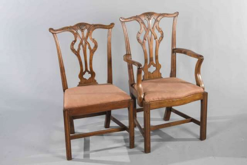 A MATCHED SET OF EIGHT GEORGE III STYLE MAHOGANY DINING CHAIRS, including a pair of carvers, each with yoked crest rail and fret carved splat, raised on moulded square section legs.