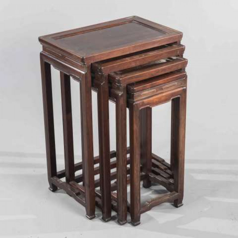 A NEST OF FOUR CHINESE HARDWOOD TABLES, the rectangular tops raised on square section legs. Largest 68cm by 48m by 31cm
