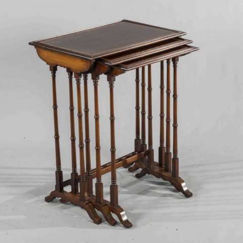 A NEST OF THREE EDWARDIAN SATINWOOD CROSSBANDED MAHOGANY TABLES, rectangular with 'spider' legs. 73cm by 56cm by 38cm