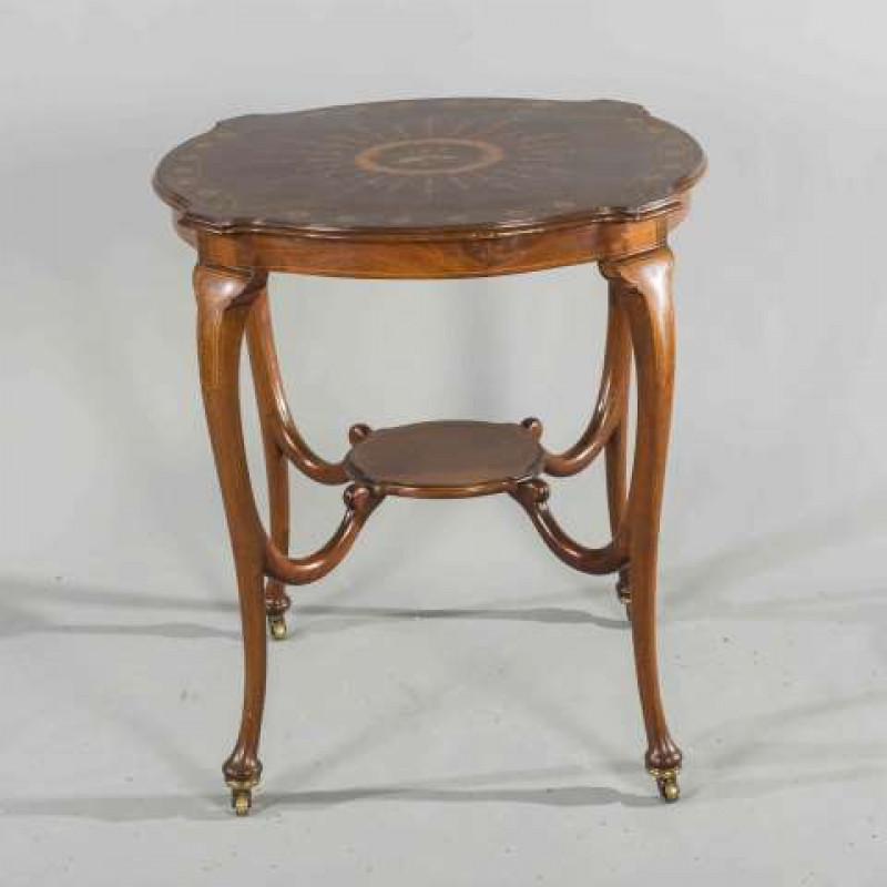 AN EDWARDIAN INLAID MAHOGANY OCCASIONAL TABLE, the moulded top of serpentine outline, inlaid with a musical trophy and Classical foliage, raised on cabriole legs, joined by a shelf stretcher, moving on castors. 75cm by 67cm by 67cm