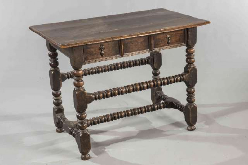 AN OAK SIDE TABLE, 17th/18th Century, with moulded rectangular top above a frieze drawer with moulded front, raised on block and bobbin legs joined by bead and reel stretchers.