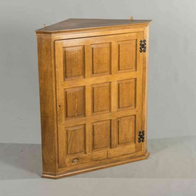DEREK SLATER, A FISHMAN OAK CORNER CUPBOARD, with nine panel door and wrought iron hinges, incised fish signature. 91cm high, 79cm wide