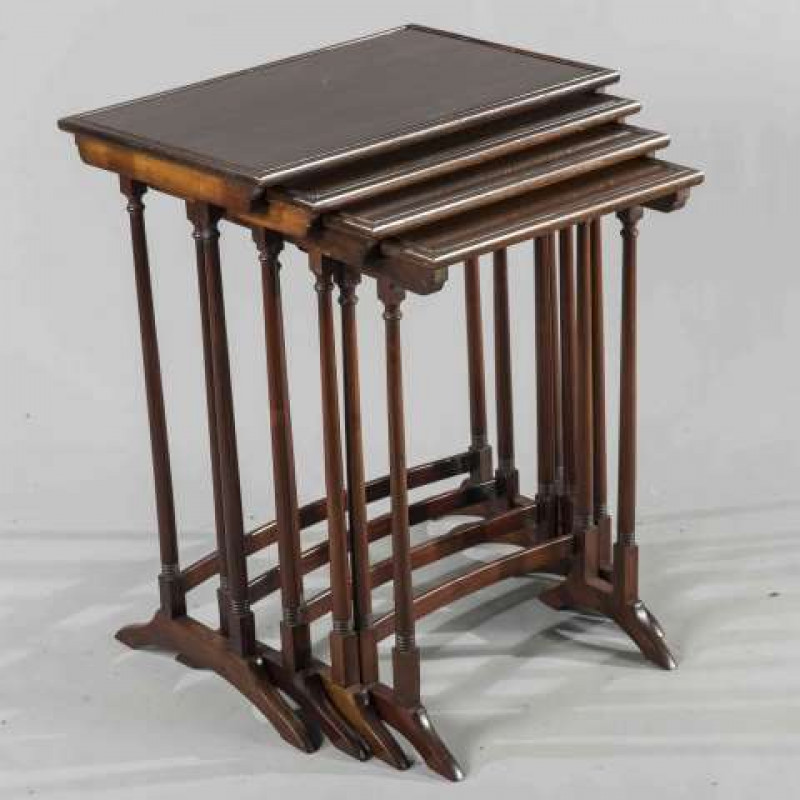 GILL & REIGATE, LONDON, A NEST OF FOUR MAHOGANY OCCASIONAL TABLES, rectangular with tapering cylindrical legs, labelled. Largest 70cm by 55.5cm by 37cm
