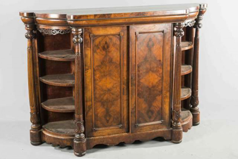 A 19TH CENTURY WALNUT CREDENZA, the breakfront top with rounded ends, over a pair of fielded panel doors flanked by tapering fluted columns, further flanked by open shelves. 117cm by 169cm by 49cm