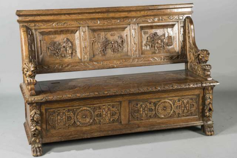 A 19TH CENTURY CARVED OAK HALL BENCH, the three panel back carved with figures in a tavern, lion carved arms, the box seat with two panel carved front. 154cm wide
