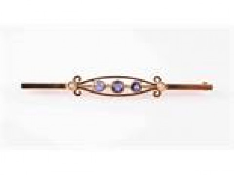 A SAPPHIRE AND SEED PEARL BROOCH, the open moulded scroll detail mount...
