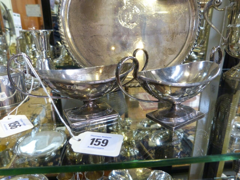 A PAIR OF LATE VICTORIAN SILVER BON BON DISHES, Hawksworth, Eyre & Co, London 1896, oval with twin handles and square foot. 9oz, 16cm across handles