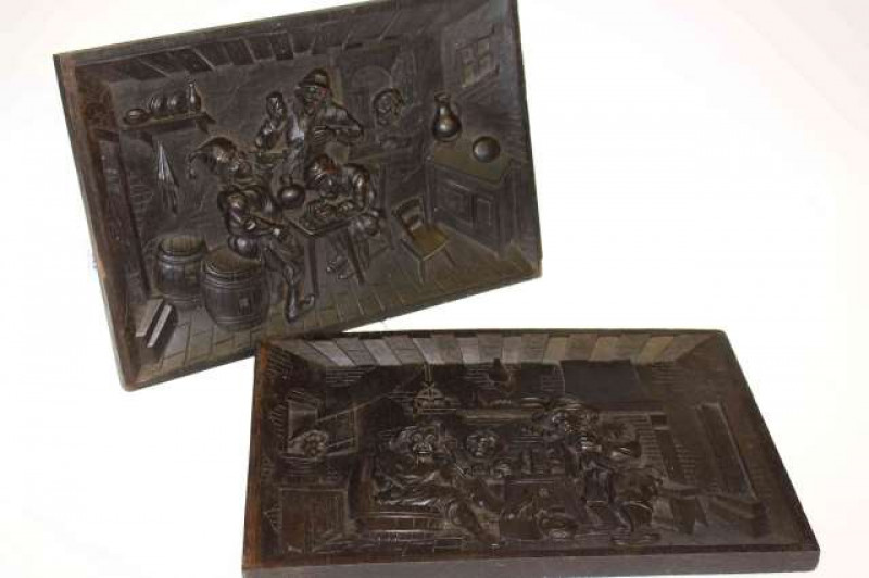 Pair of heavily carved oak panels depicting ale house scenes