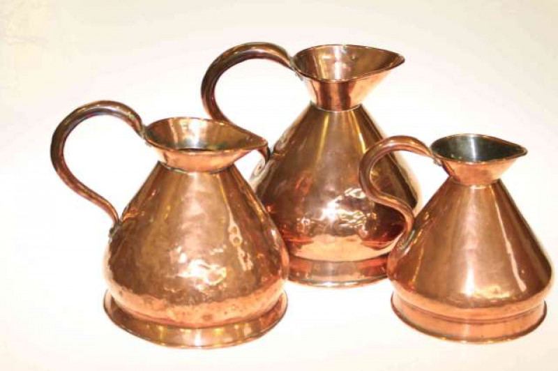 Graduated set of 19th Century copper measuring jugs