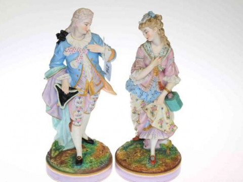 Pair of 19th Century tinted bisque figures of a lady and gentleman in...