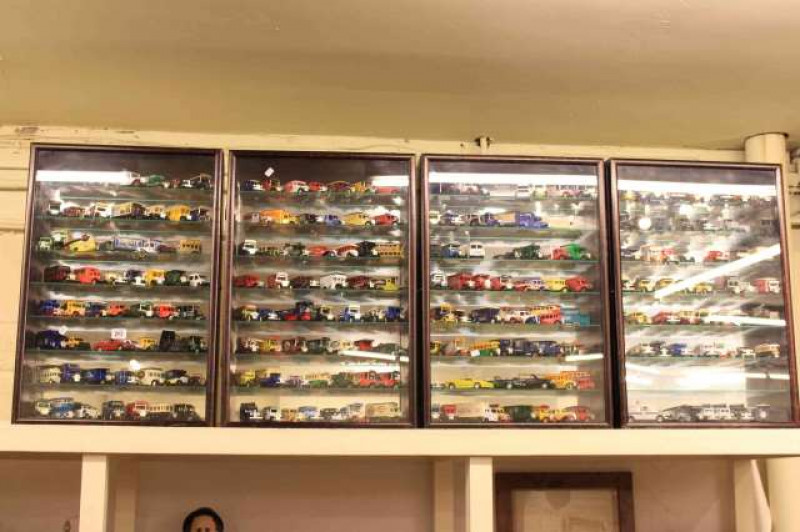 Four wall mounted display cases containing collection of model vehicles