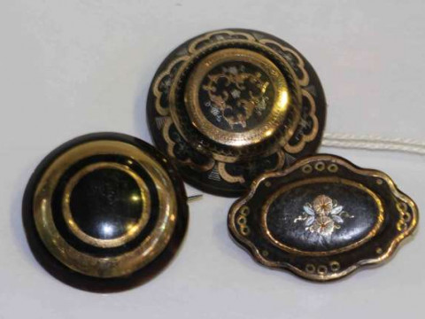 Three pique brooches