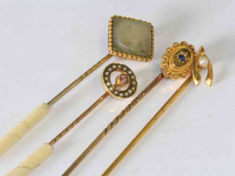 Three gold stock pins and another (4)