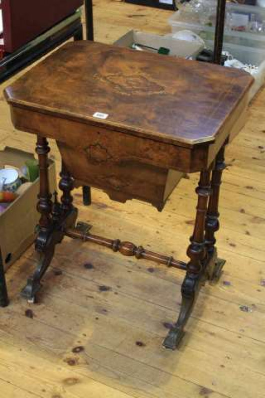 Victorian walnut, satinwood and ebony inlaid sewing table raised on four turned pillars to splayed legs