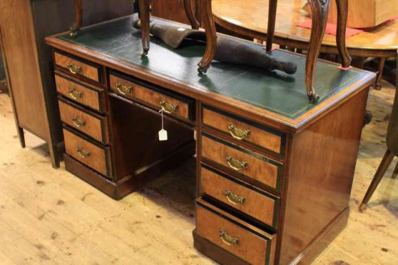 Victorian walnut eight drawer pedestal desk having green leather studded back