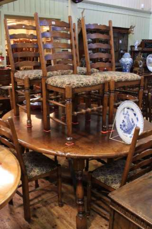 Large oval oak dining table and eight ladder back chairs