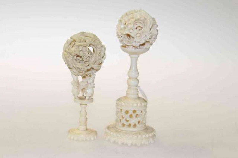 Two Chinese carved ivory puzzle balls on stands, probably 19th Century
