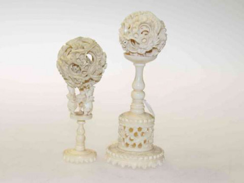 Two Chinese carved ivory puzzle balls on stands, probably 19th Century