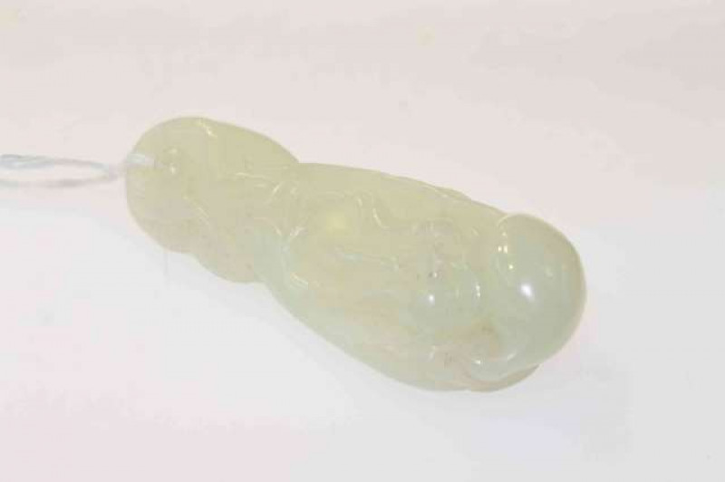A Chinese jadeite pendant, carved as a Shou Lao, 7.5cm