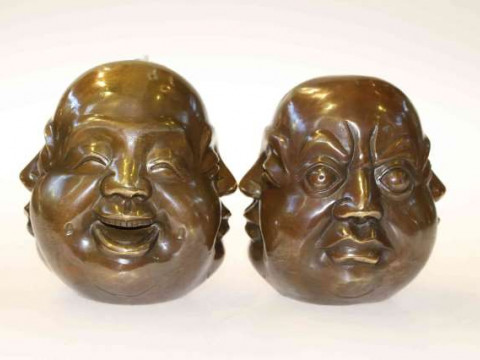 Pair of bronze buddha heads, each with four facial expressions