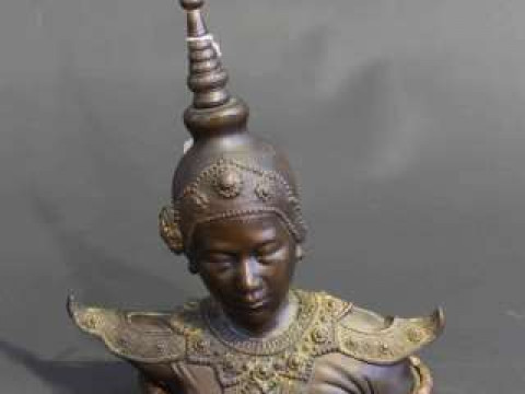 Tibetan bronze bust, probably 19th Century, on a carved wood stand
