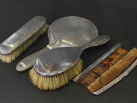 Three silver mounted dressing table articles and two combs (5)