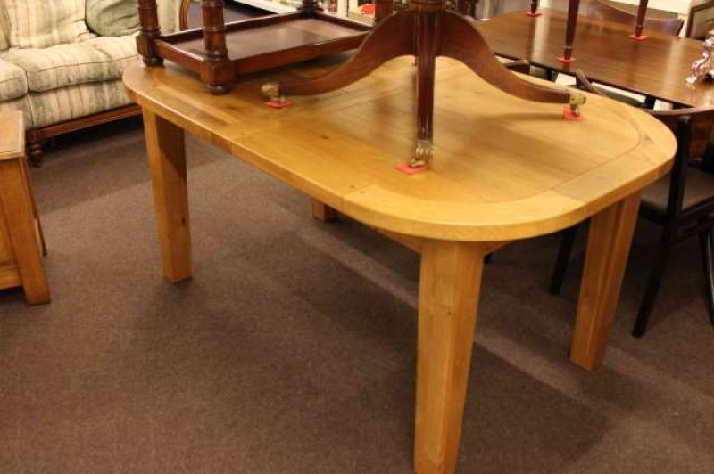 Modern light wood finish G-Plan dining table with integral leaf raised on square tapering legs