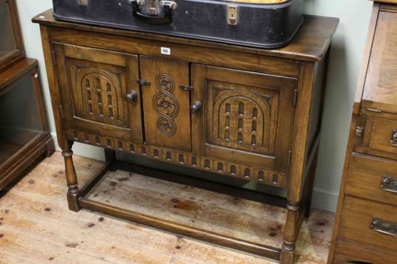 Carved oak two door side cabinet