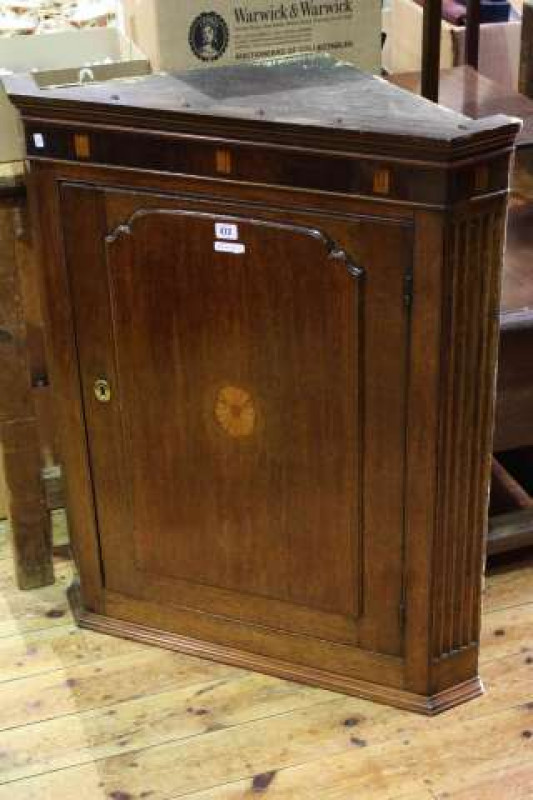 Victorian oak, mahogany and satinwood corner wall cupboard having arched fielded panel door