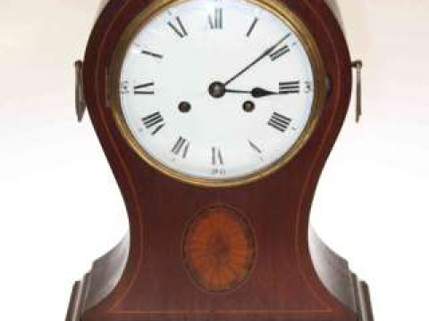 Inlaid mahogany balloon mantel clock with brass handles and enamel dial