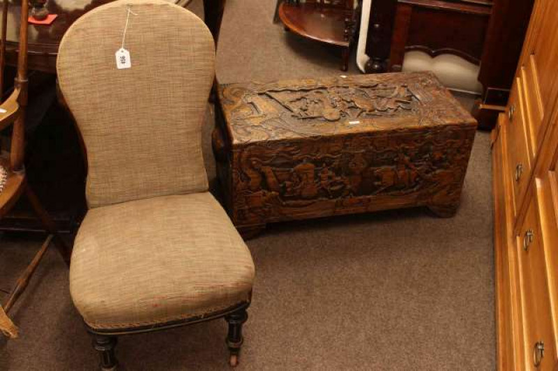 Carved camphorwood trunk and Victorian ebonised nursing chair (2)