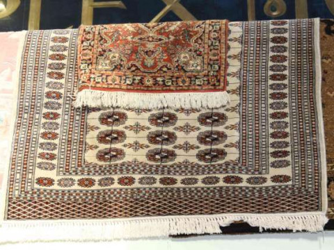 Fawn ground wool rug 1.80 x 1.30 and small red ground wool rug 0.95 x...