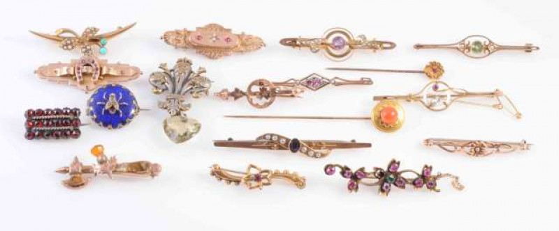 A COLLECTION OF EIGHTEEN GEORGIAN AND VICTORIAN BROOCHES AND TIE PINS, of varying designs and shapes, most set with gem stones to include peridot, turquoise, seed pearls and amethyst. Most stamped 375 or 9CT. One stamped 15CT. Total weight 53.2gms.