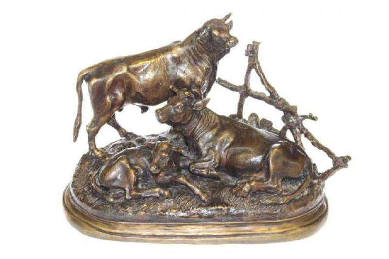 Bronze of three bulls by a fence