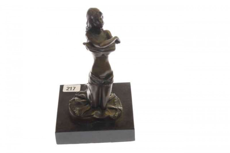 Bronzed figure of a scantily clad maiden